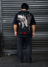 Model from behind wearing the Warmonger Premium oversized tee in black with dragon back print