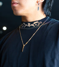 Collar detail with chain and neck print on the Strength Within Premium oversized tee in black