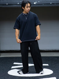 Model wearing the Gatekeeper Premium oversized tee in black with black pants, front view