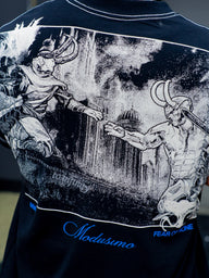 Close-up of the Gatekeeper classical battle artwork and blue script on the black tee