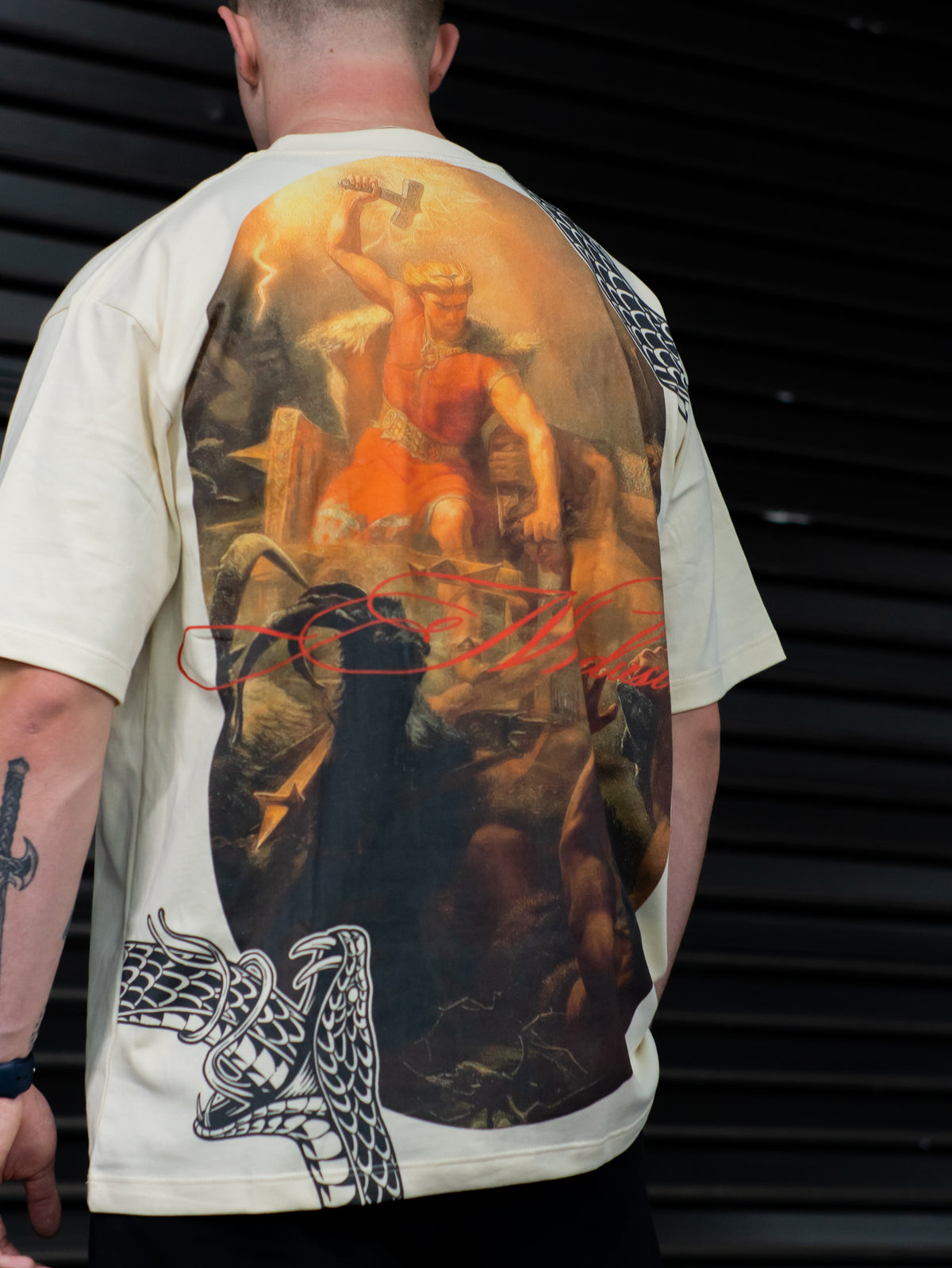 Close-up of the Thunder classical painting back print on the pastel cream Premium tee, worn — second view