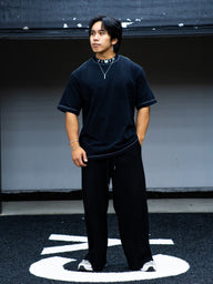 Model wearing the Fenrir Premium oversized tee in black with black pants, front view