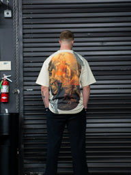 Model from behind wearing the Thunder Premium oversized tee in pastel cream with painting print