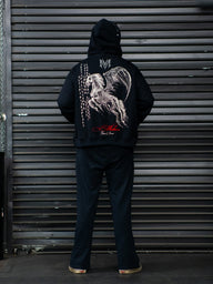 Model from behind wearing the Into Battle stringed hoodie in black with hood up