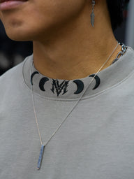 Collar detail with moon phase neck print on the Chase the Night Premium oversized tee in snakestone