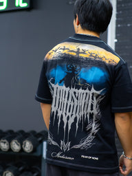 Close-up of the Ragnarok metal logo back print on the black Premium oversized tee, worn