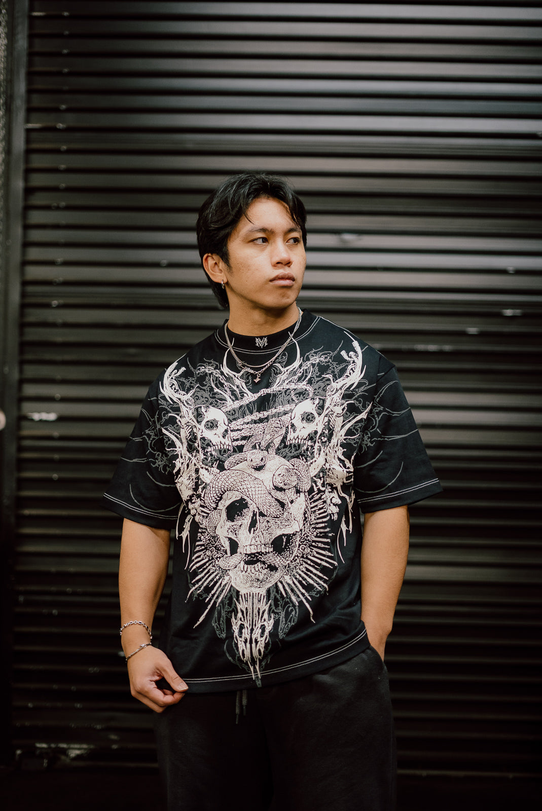 Model wearing the Forsaken Premium oversized tee in black with skull and wings front print — second view