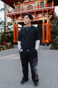 Model wearing the Set Your Heart Premium oversized tee in black with printed pants, front view