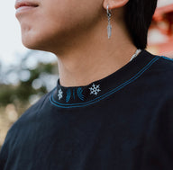 Collar detail with neck logo on the Set Your Heart Premium oversized tee in black, worn