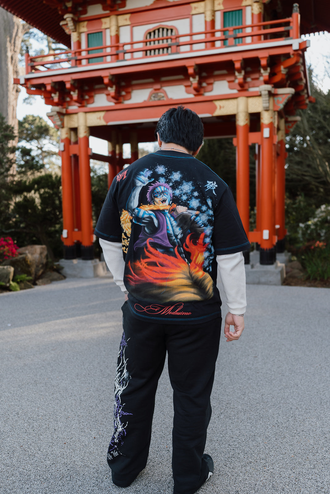 Model from behind wearing the Set Your Heart Premium oversized tee in black at a red shrine gate — second view