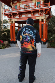 Model from behind wearing the Set Your Heart Premium oversized tee in black at a red shrine gate
