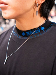 Collar detail with blue neck print on the Royal Flush Premium oversized tee in black, worn