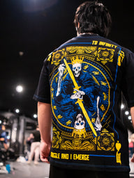 Close-up of the Royal Flush blue and gold card back print on the black Premium tee, worn